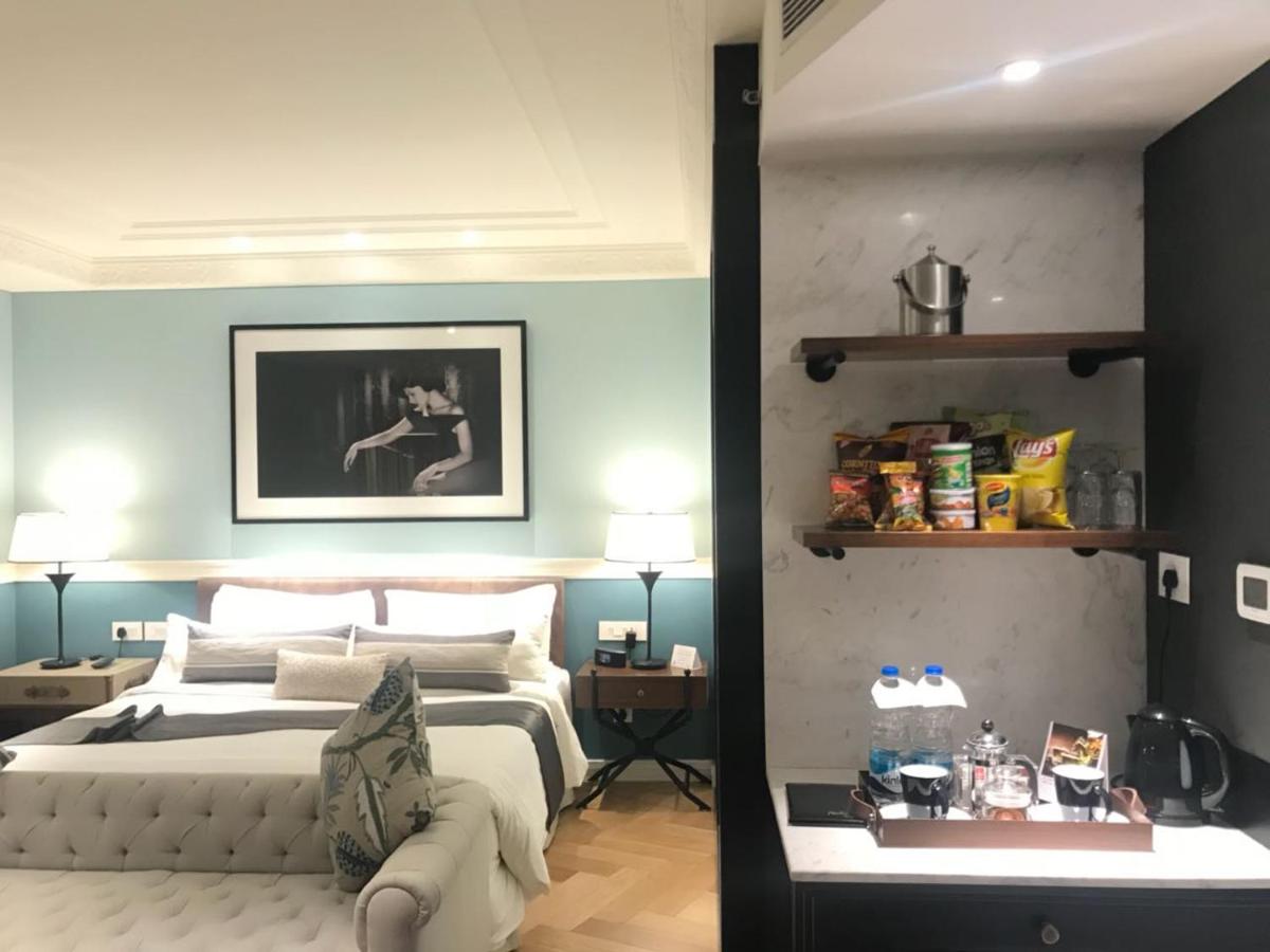 a bedroom with a king sized bed with blue walls at Radisson Hotel Shimla in Shimla