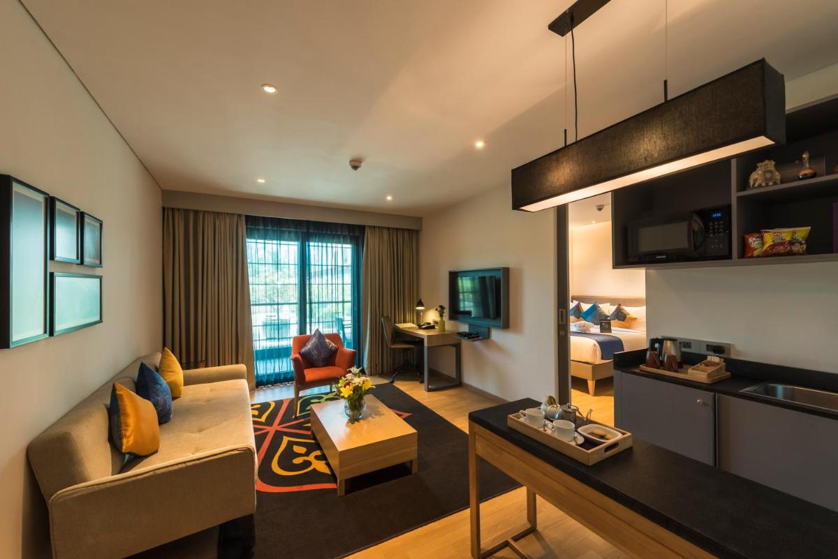 a living room with a couch and a table at Grand Mercure Mysore - An Accor Brand in Mysore