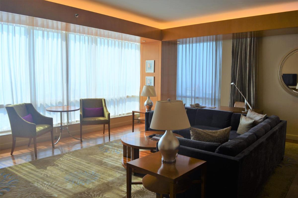 a living room with a couch and a table at Four Seasons Hotel Mumbai in Mumbai