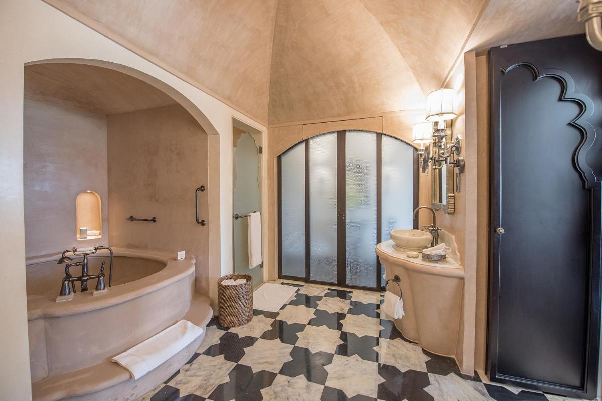 a bathroom with a tub and a sink at Fairmont Jaipur in Jaipur