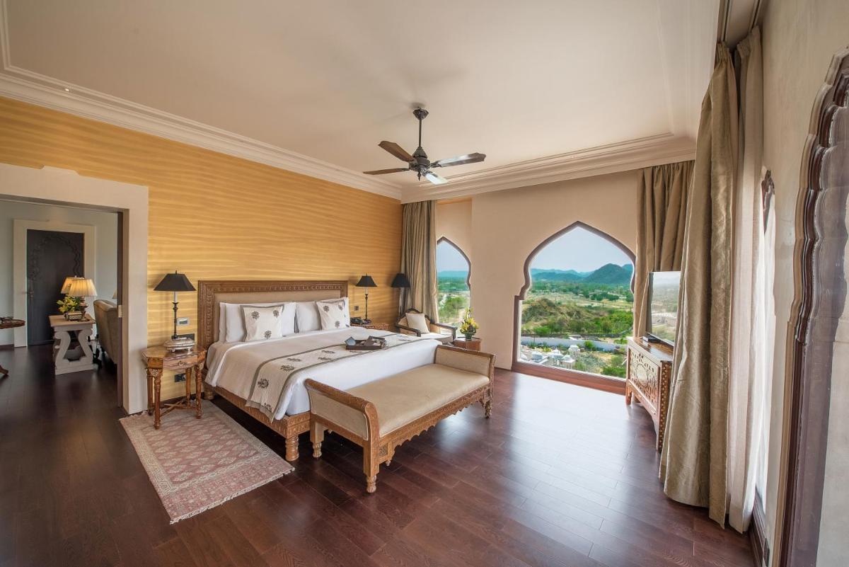 a large bedroom with a bed and a large window at Fairmont Jaipur in Jaipur