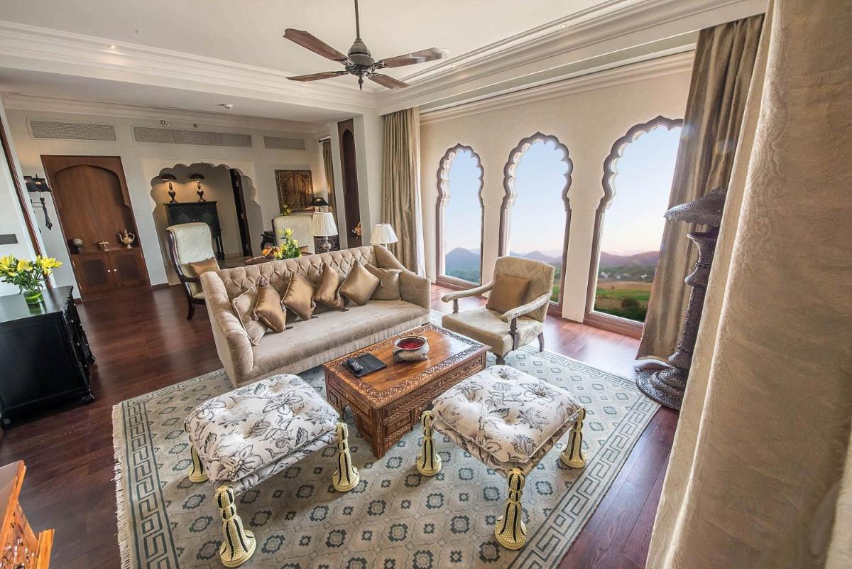 a living room with a couch and a table at Fairmont Jaipur in Jaipur