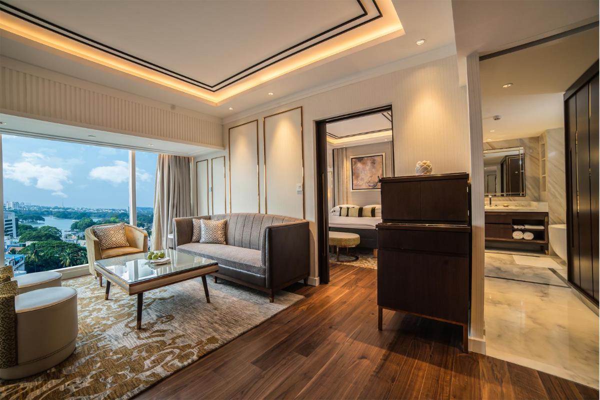 a living room with a couch and a table at Taj MG Road Bengaluru in Bengaluru a living room with a couch and a table at Taj MG Road Bengaluru in Bengaluru