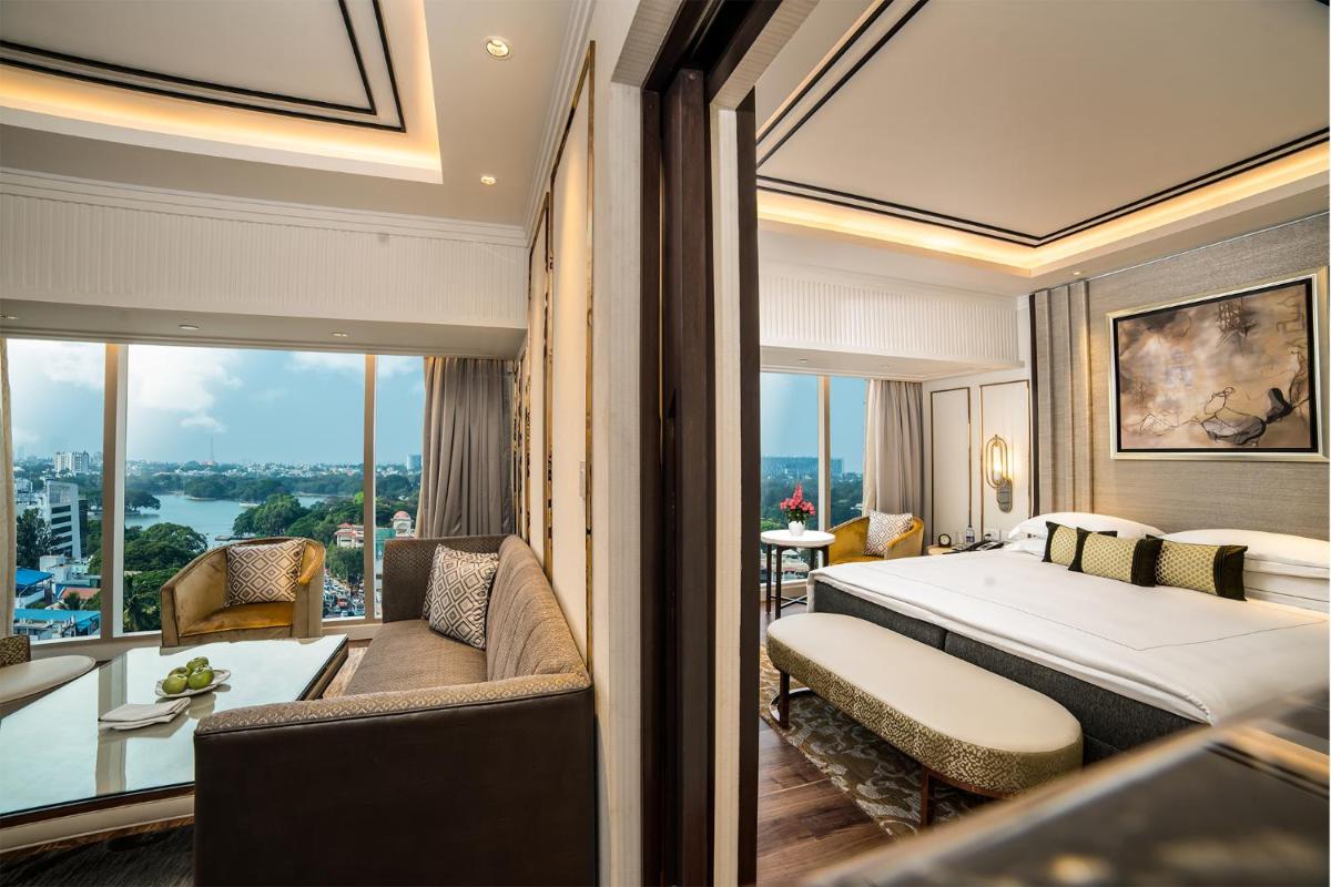 a hotel room with a bed and a large window at Taj MG Road Bengaluru in Bengaluru a hotel room with a bed and a large window at Taj MG Road Bengaluru in Bengaluru