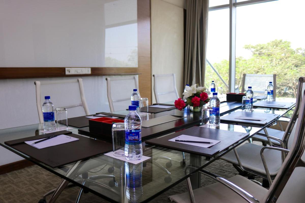 a conference room with a table with water bottles on it at Radisson Blu Hotel, Greater Noida in Greater Noida