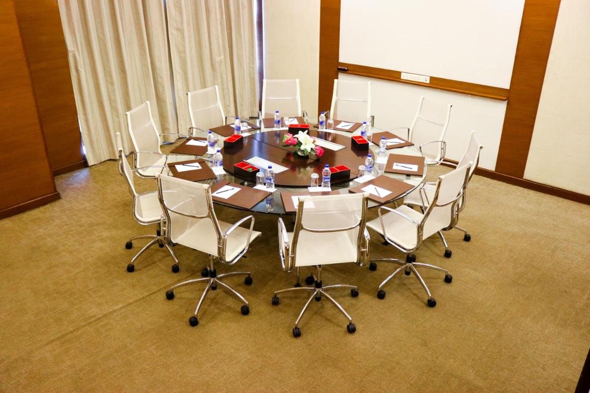 a conference room with a large table and chairs at Radisson Blu Hotel, Greater Noida in Greater Noida