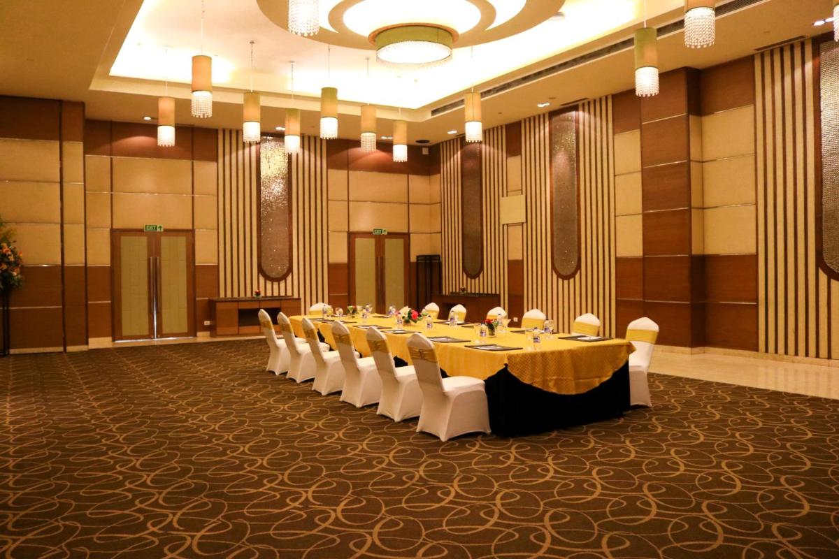 a conference room with a long table and chairs at Radisson Blu Hotel, Greater Noida in Greater Noida