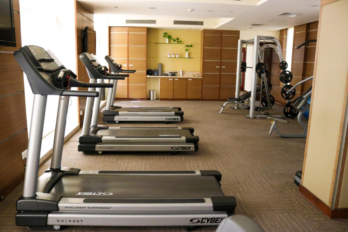 a row of treadmills in a gym at Radisson Blu Hotel, Greater Noida in Greater Noida