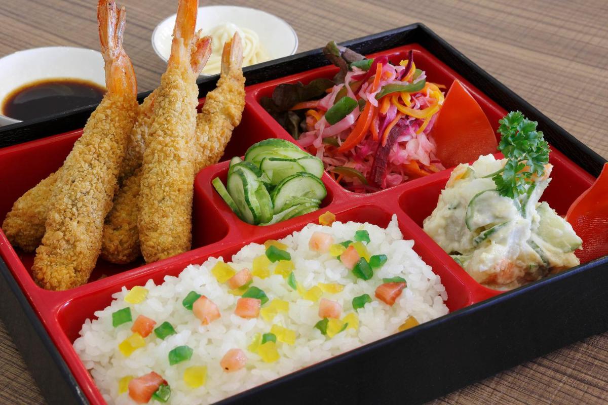 a tray of food with rice and vegetables on a table at Novotel Chennai Chamiers Road in Chennai