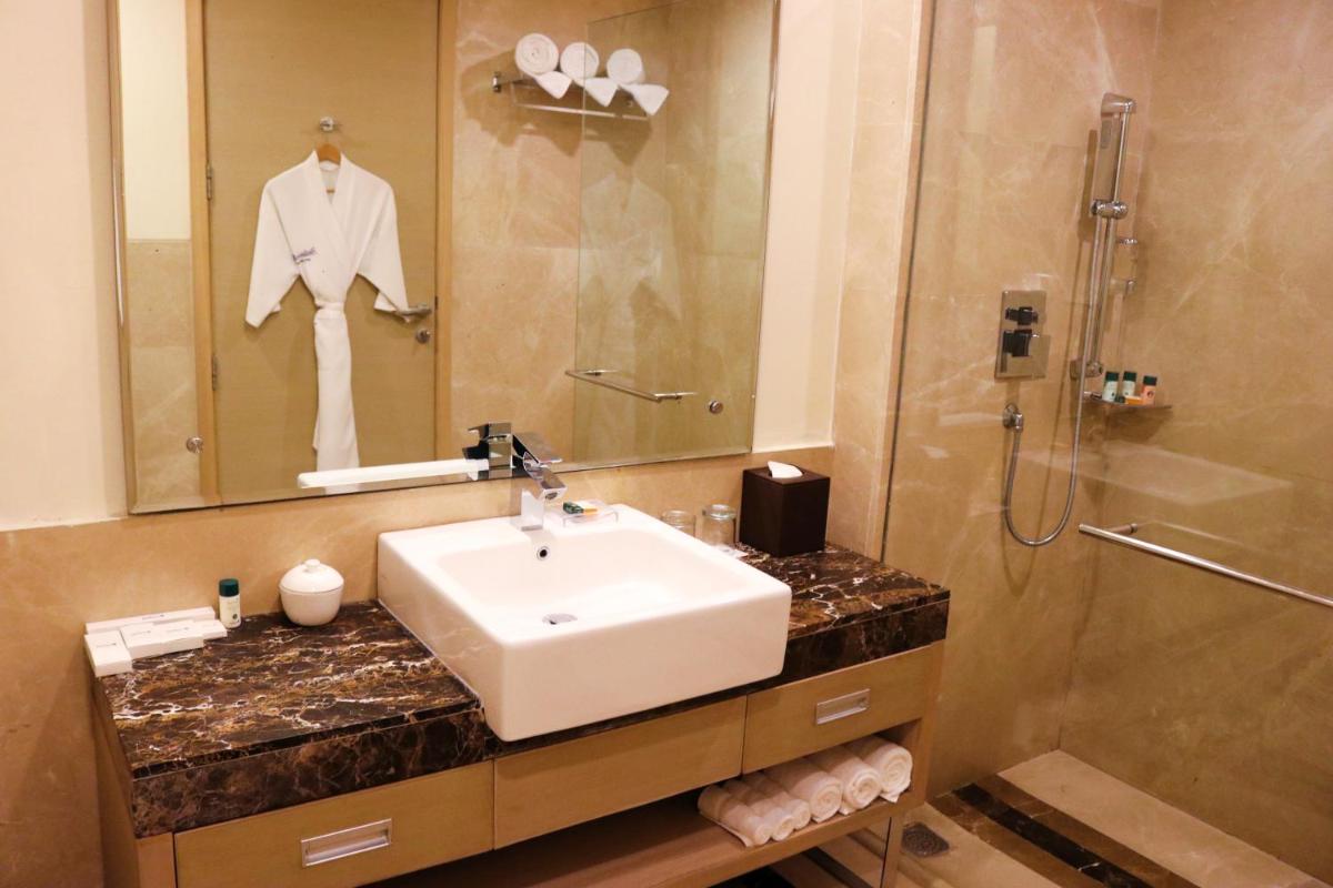 a bathroom with a sink and a shower at Radisson Blu Hotel, Greater Noida in Greater Noida
