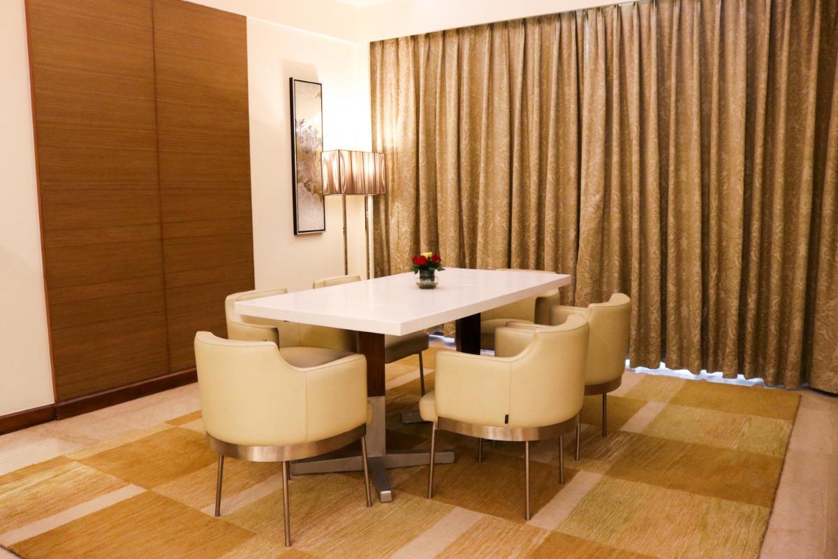 a dining room with a table and chairs at Radisson Blu Hotel, Greater Noida in Greater Noida