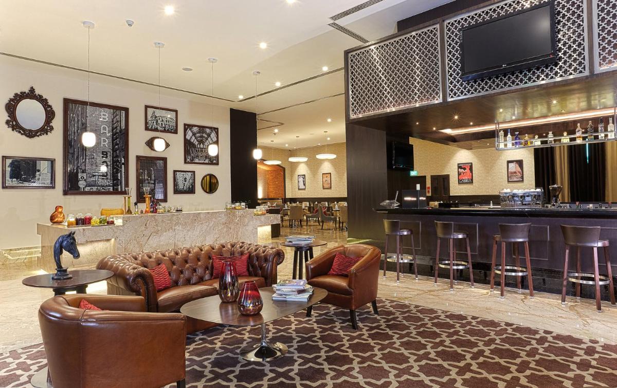a lobby with couches and a bar in a hotel at The Oterra in Bengaluru