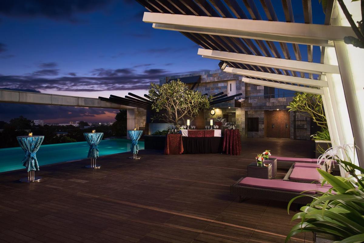 an outdoor patio with a pool at night at The Oterra in Bengaluru