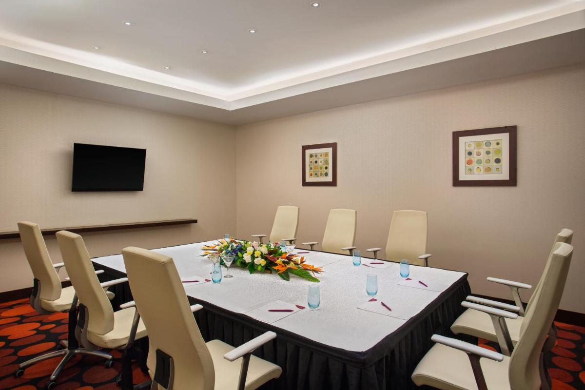 a conference room with a long table and chairs at The Oterra in Bengaluru