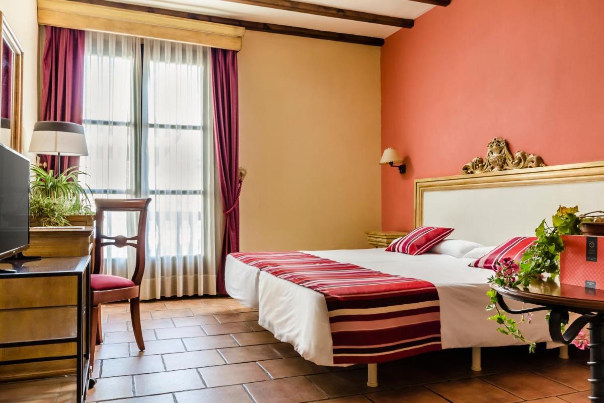 Cama o camas de una habitación en Hotel Rural Los Nogales