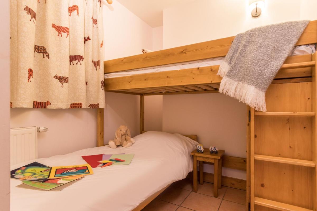 Un ou plusieurs lits dans un hébergement de l'établissement Résidence Pierre & Vacances Premium Les Hauts Bois