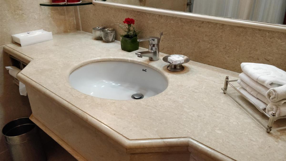 a bathroom counter with a sink in a bathroom at Jaypee Vasant Continental in New Delhi