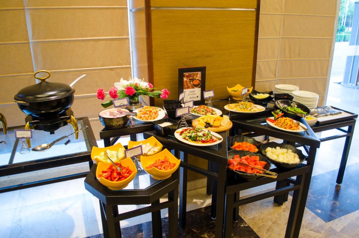 a buffet with several plates of food on a table at Radisson Blu Hotel, Greater Noida in Greater Noida