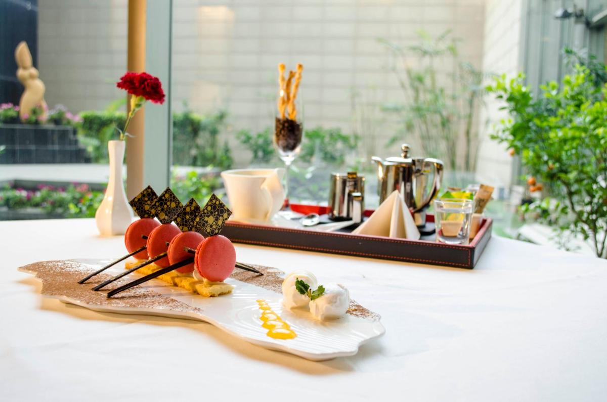 a plate of food on a table with chopsticks at Radisson Blu Hotel, Greater Noida in Greater Noida