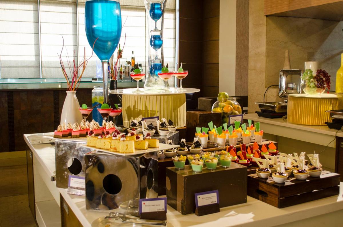 a buffet with many different types of food on a table at Radisson Blu Hotel, Greater Noida in Greater Noida