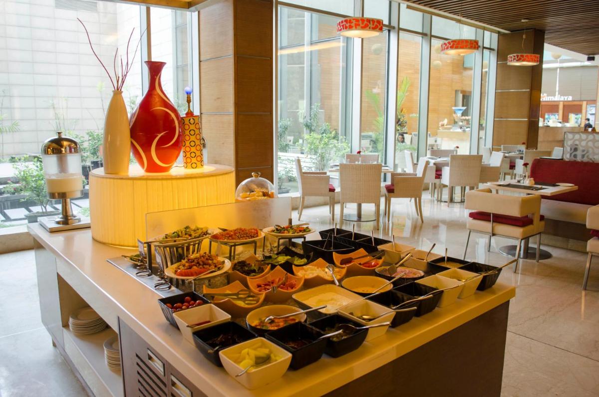 a buffet with a bunch of food on a table at Radisson Blu Hotel, Greater Noida in Greater Noida
