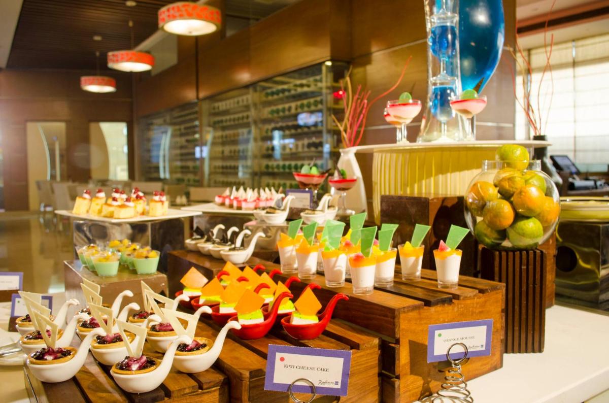 a display of shoes and other desserts in a restaurant at Radisson Blu Hotel, Greater Noida in Greater Noida
