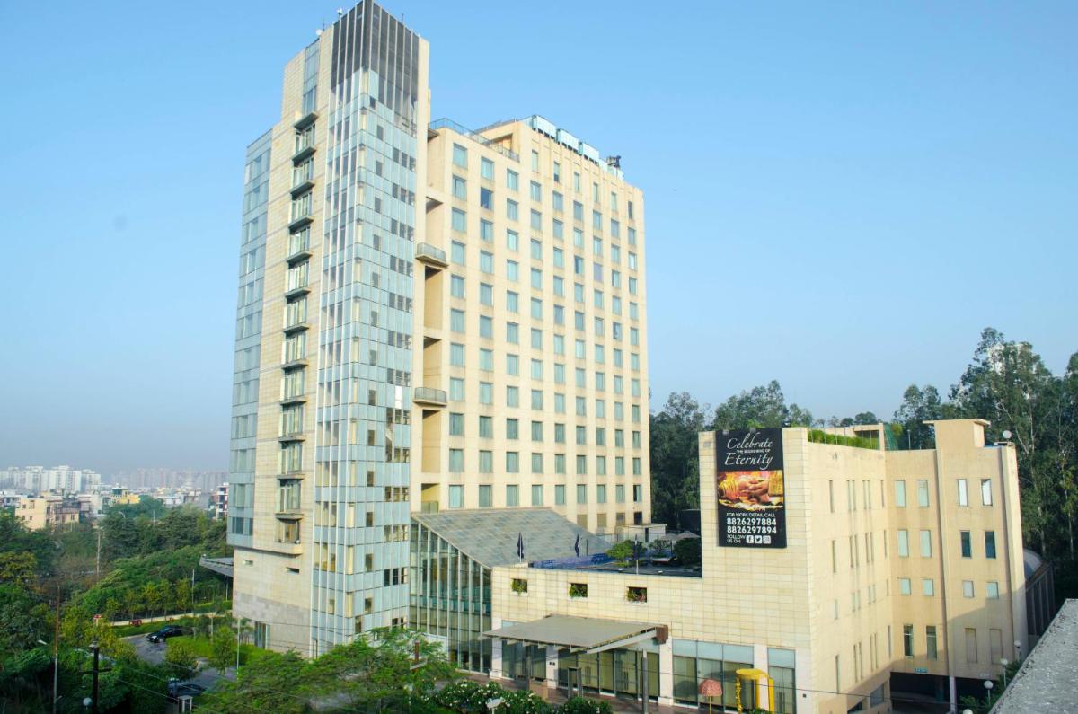a tall building with a sign on the side of it at Radisson Blu Hotel, Greater Noida in Greater Noida