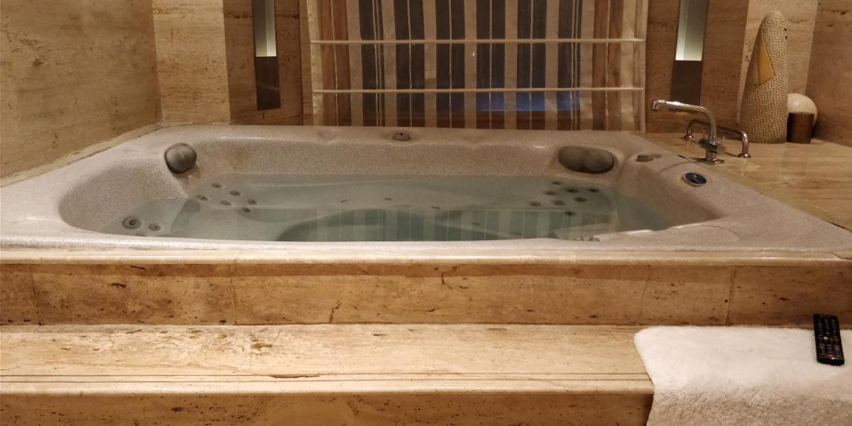 a large bath tub in a bathroom at Jaypee Vasant Continental in New Delhi
