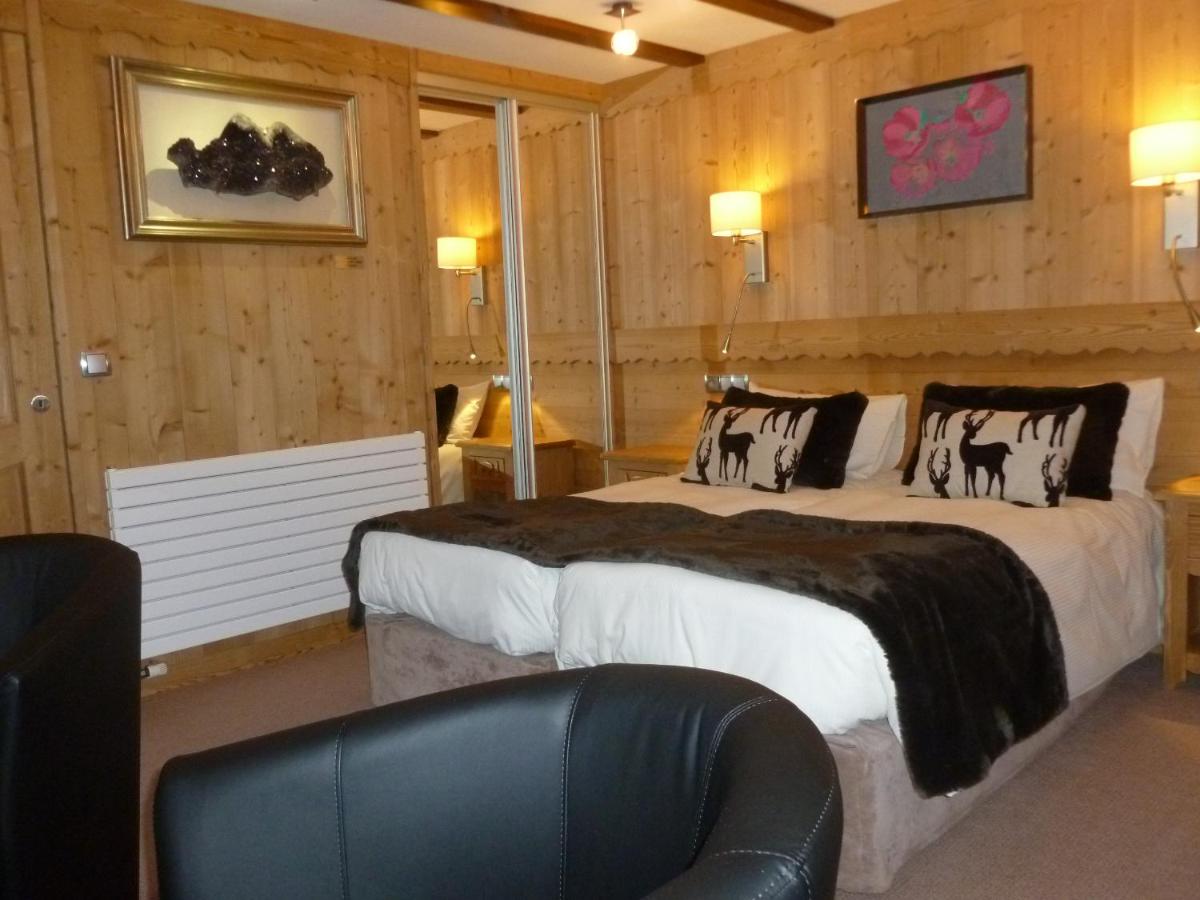 Un ou plusieurs lits dans un hébergement de l'établissement Aiguille du Midi - Hôtel & Restaurant