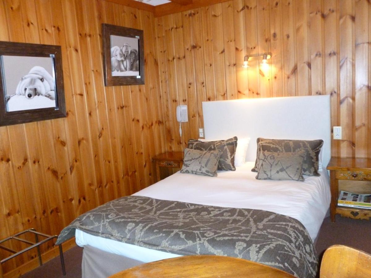 Un ou plusieurs lits dans un hébergement de l'établissement Aiguille du Midi - Hôtel & Restaurant