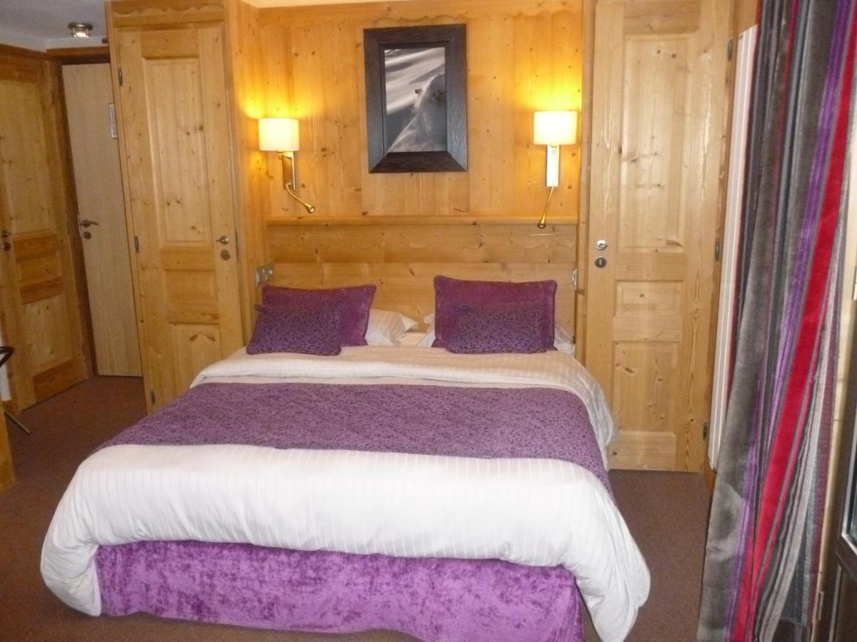 Un ou plusieurs lits dans un hébergement de l'établissement Aiguille du Midi - Hôtel & Restaurant