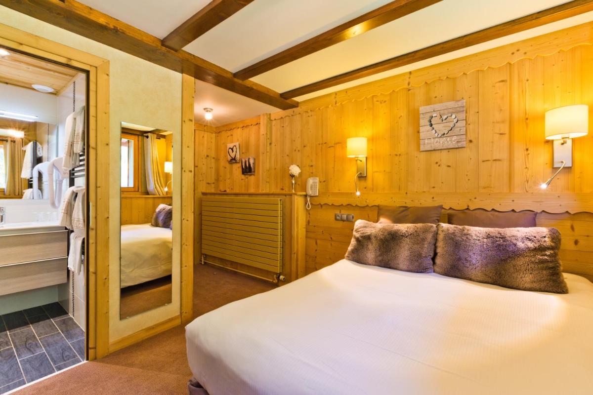 Un ou plusieurs lits dans un hébergement de l'établissement Aiguille du Midi - Hôtel & Restaurant