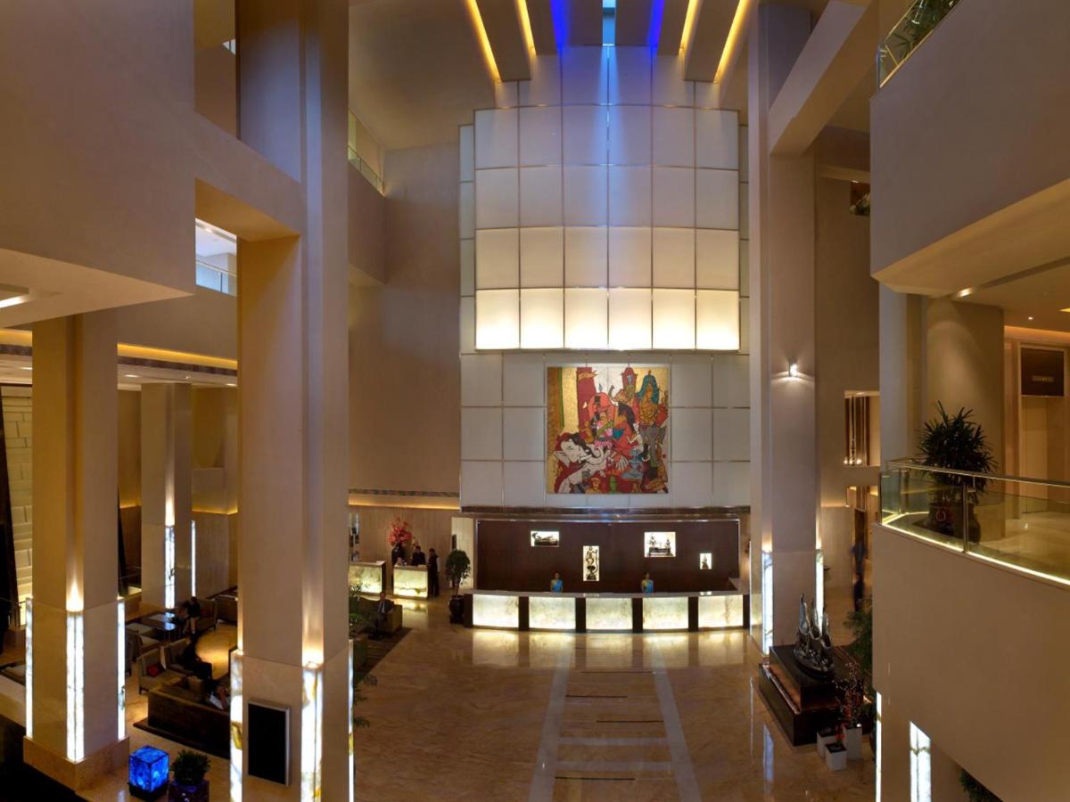 a lobby of a building with a large ceiling at The LaLiT New Delhi in New Delhi