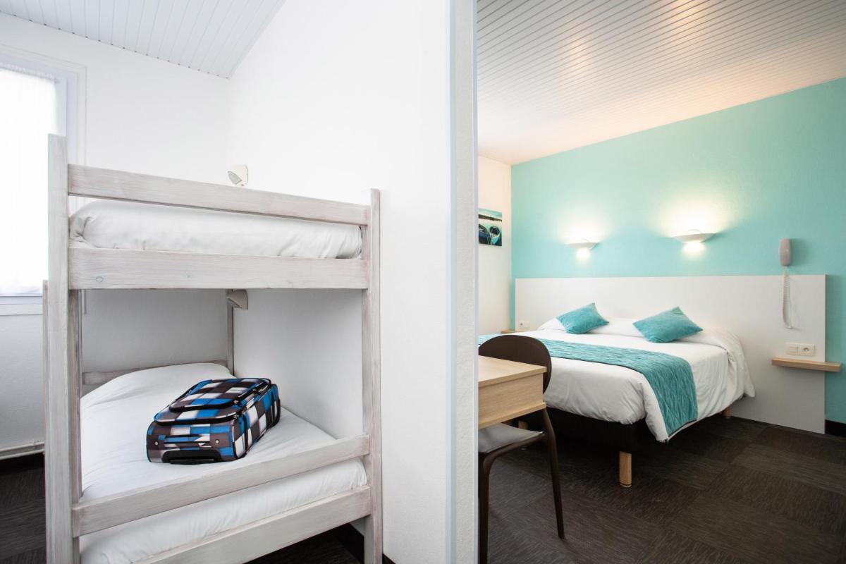 Un ou plusieurs lits dans un hébergement de l'établissement Hotel Les Dunes