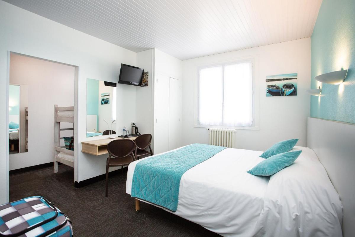 Un ou plusieurs lits dans un hébergement de l'établissement Hotel Les Dunes