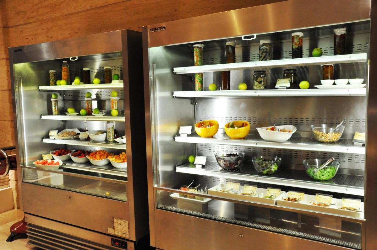 a refrigerator filled with lots of food and drinks at The Suryaa New Delhi in New Delhi a refrigerator filled with lots of food and drinks at The Suryaa New Delhi in New Delhi