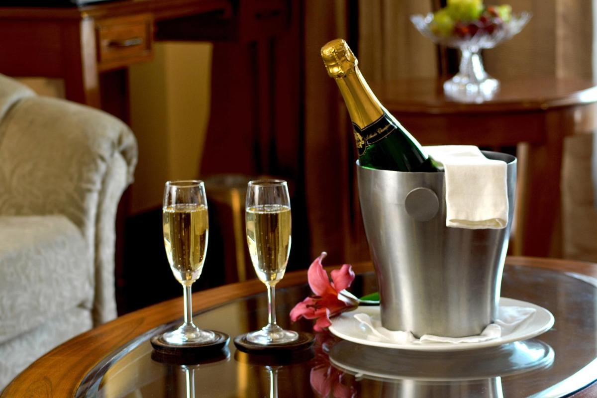 a bottle of champagne in a bucket on a table with two glasses at Radisson Hotel Shimla in Shimla