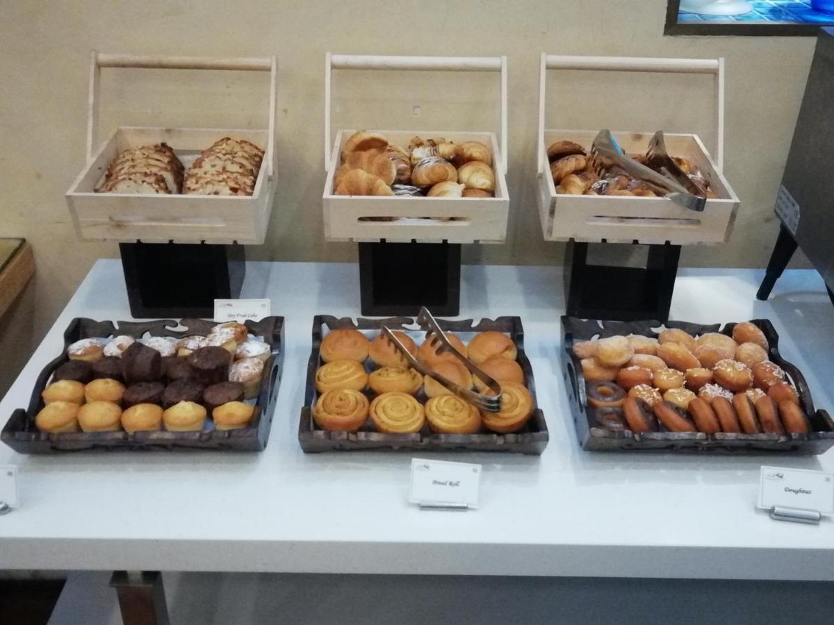 a counter with many different types of donuts in boxes at Jaypee Vasant Continental in New Delhi