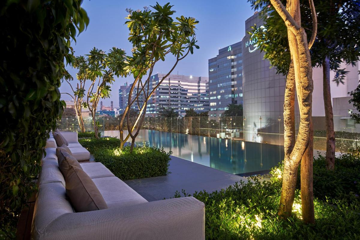 a view of a pool in a building with trees at The Den, Bengaluru in Bengaluru