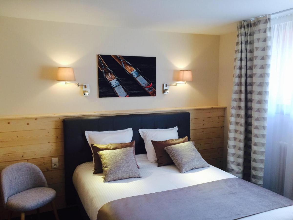 Un ou plusieurs lits dans un hébergement de l'établissement Hôtel Spa & Restaurant Ô Pervenches