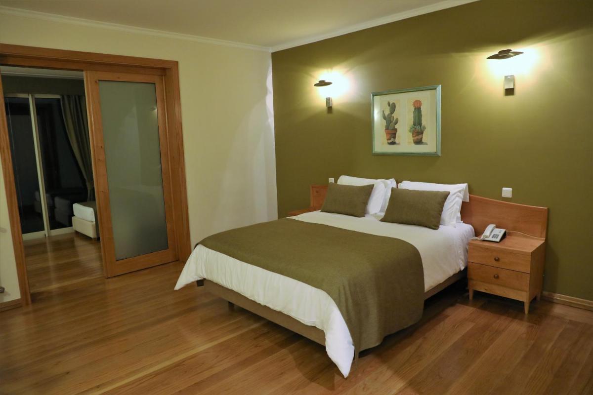 Uma cama ou camas num quarto em Eira do Serrado - Hotel & Spa