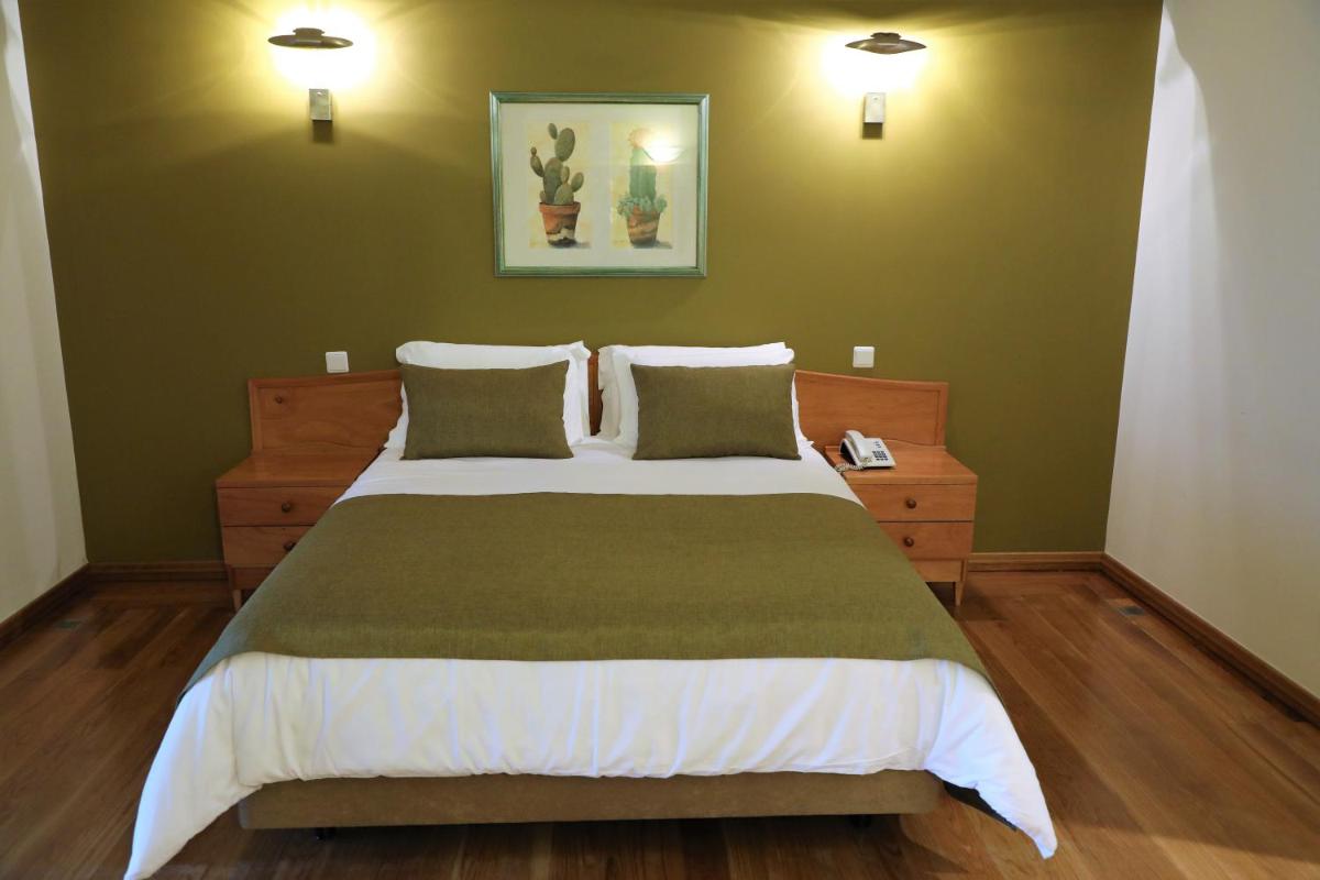 Uma cama ou camas num quarto em Eira do Serrado - Hotel & Spa