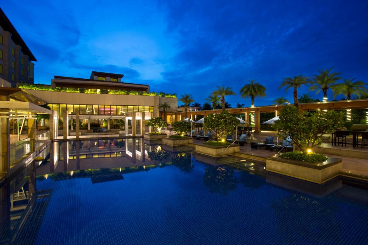 a hotel with a pool in front of a building at Novotel Hyderabad Airport in Hyderabad