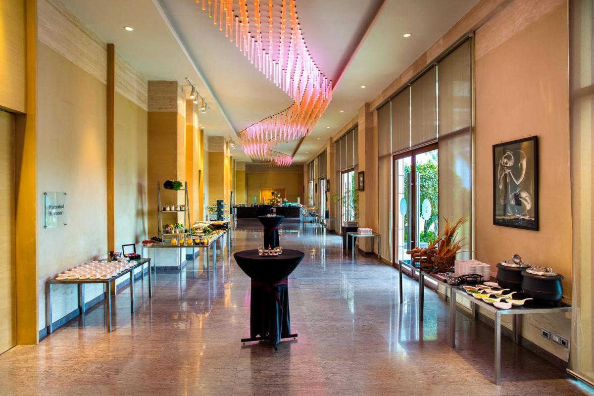 a long hallway with a store with many different types of cosmetics at Novotel Hyderabad Airport in Hyderabad