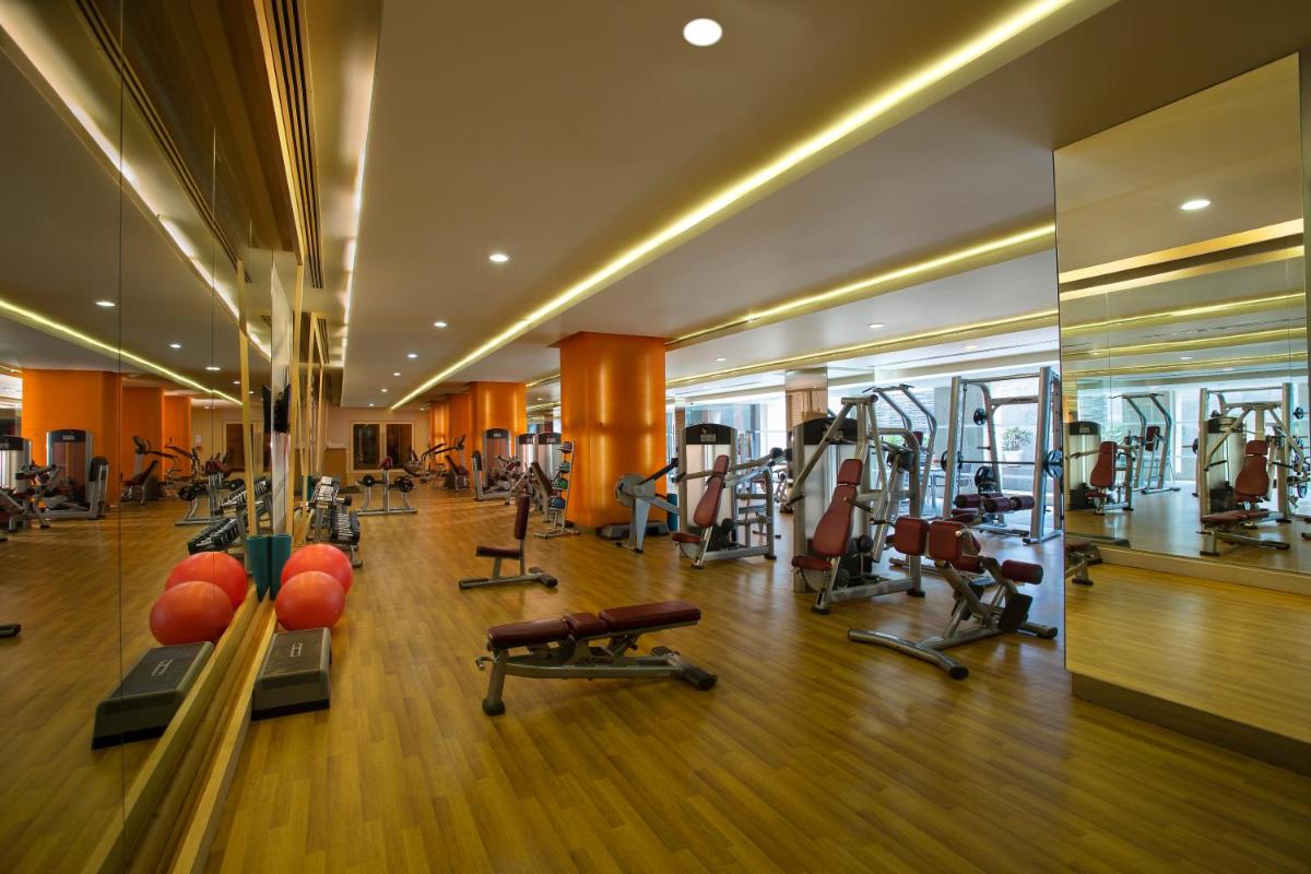 a gym with treadmills and exercise equipment in a building at Novotel Hyderabad Airport in Hyderabad