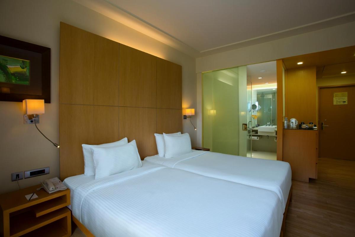 a large white bed in a hotel room at Novotel Hyderabad Airport in Hyderabad