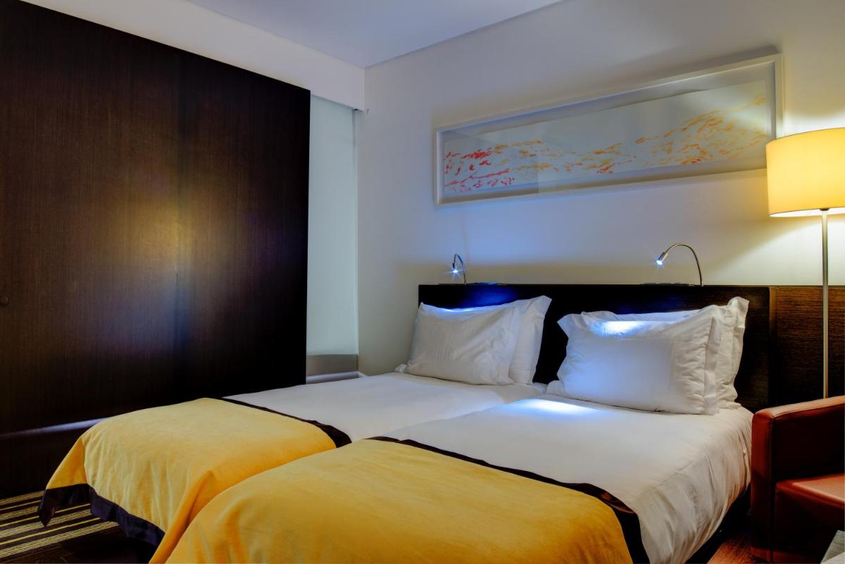 Uma cama ou camas num quarto em VIP Grand Lisboa Hotel & Spa