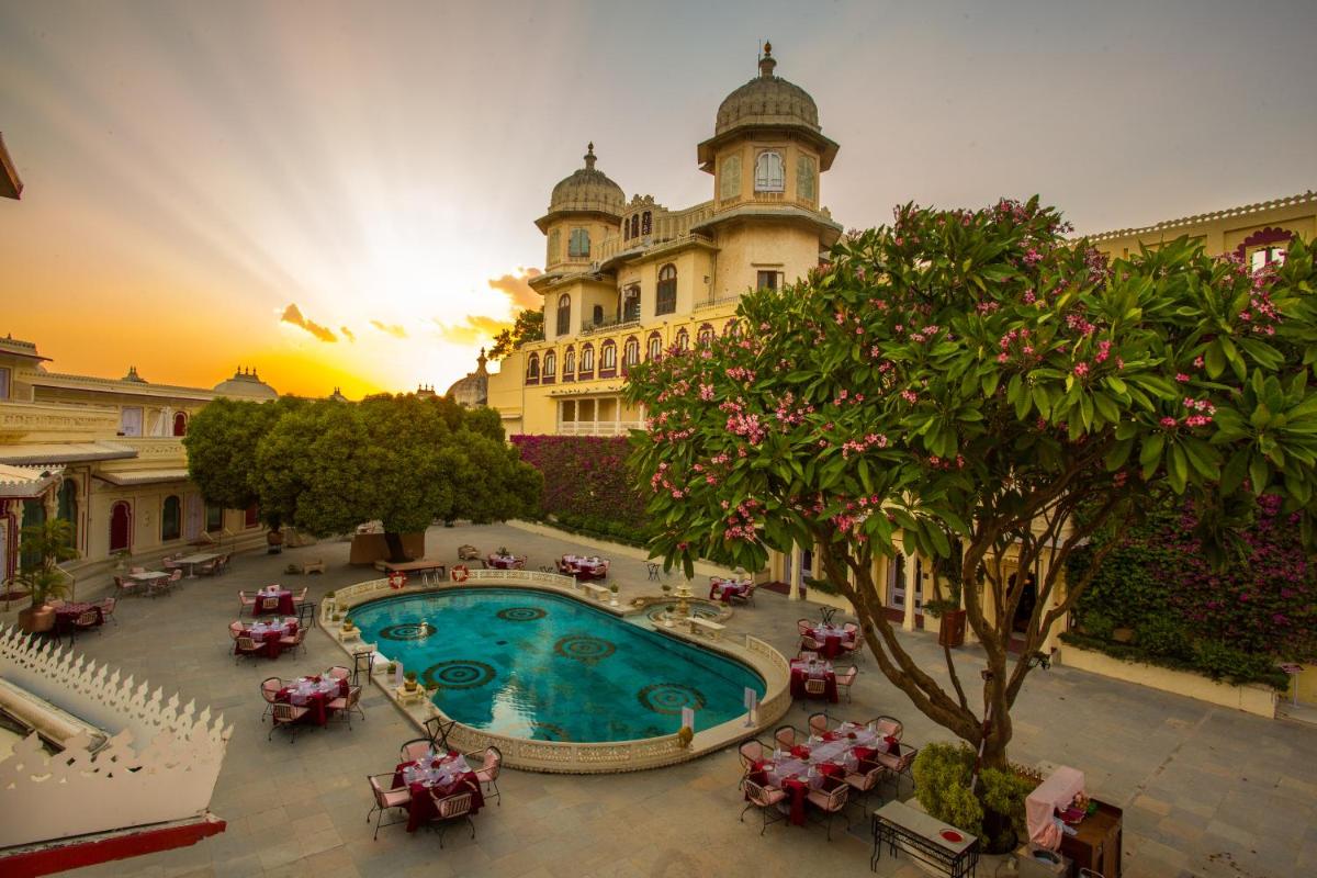 a large building with a swimming pool in front of it at Shiv Niwas Palace by HRH Group of Hotels in Udaipur