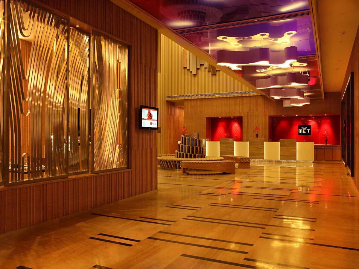 a large room with a lobby with chairs and a floor at The Metropolitan Hotel & Spa New Delhi in New Delhi