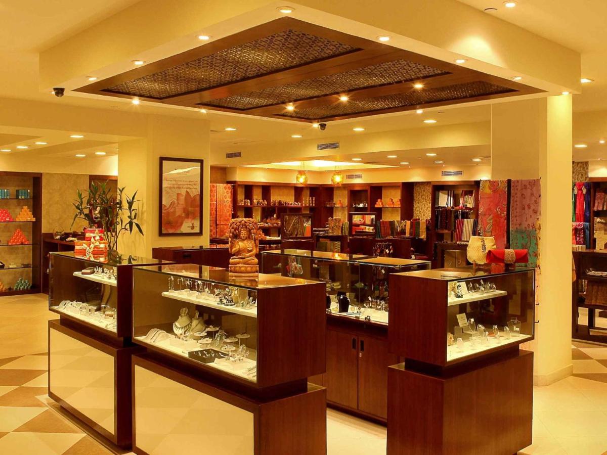 a store with many glass display cases in a room at The Metropolitan Hotel & Spa New Delhi in New Delhi